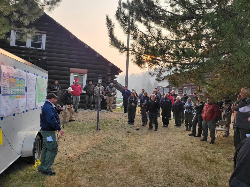 Fire crews on the Williams Creek Fire meet for their daily fire briefing.