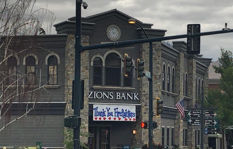 A firefighter thank you sign hangs from Zions bank