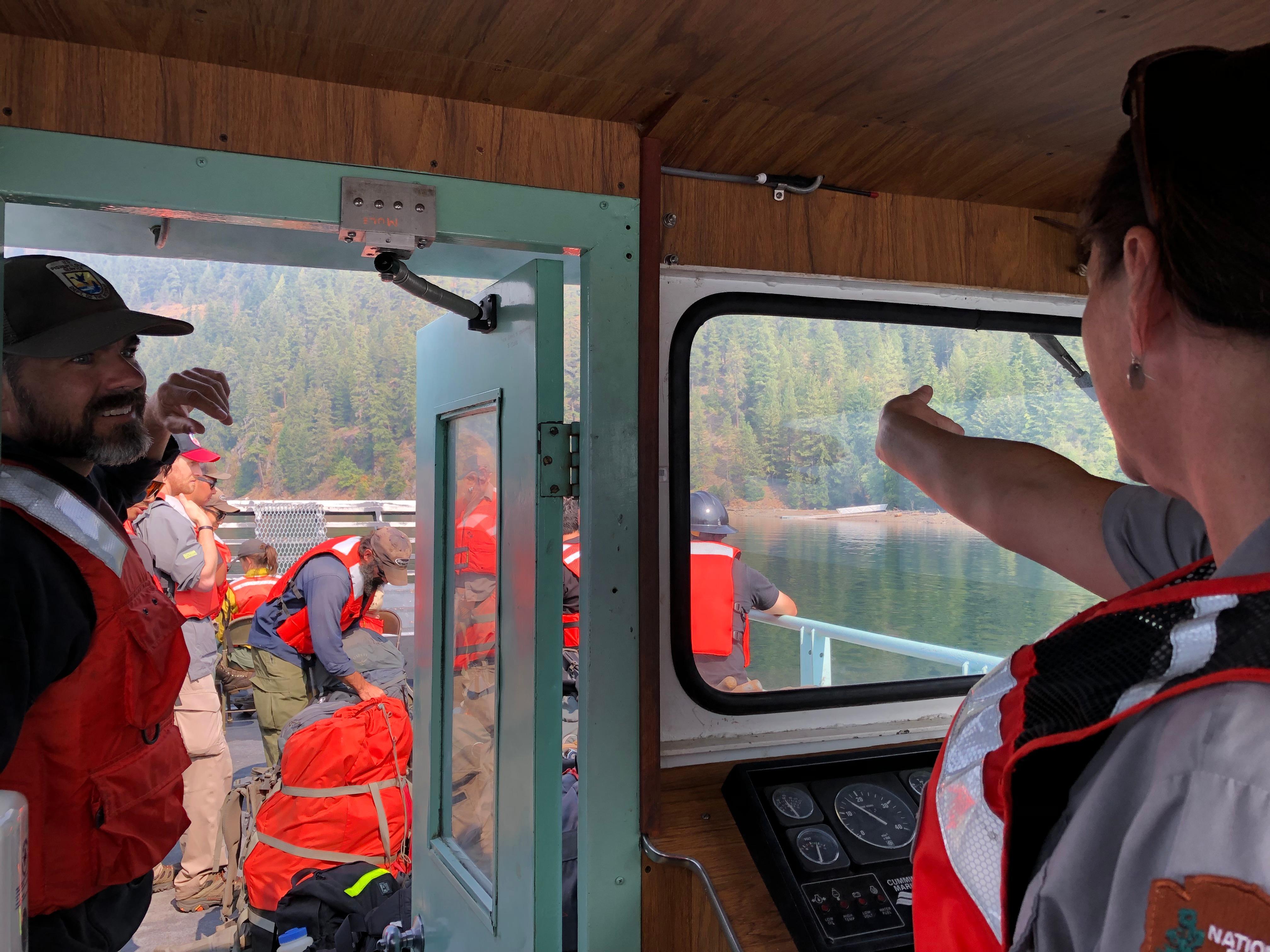 National Park Service boat operator shuttling firefighters to Hozomeen to conduct structure protection assessment.