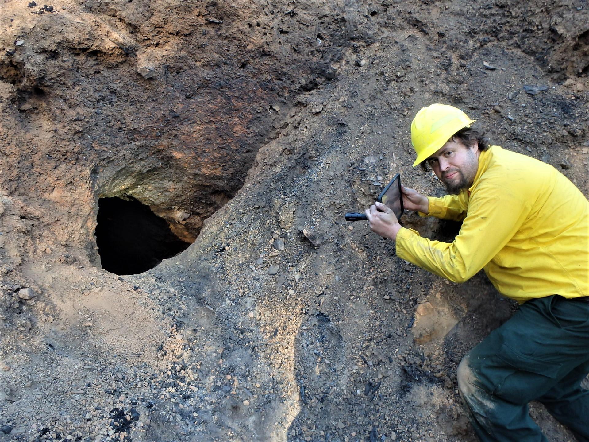 Image showing BAER abandoned mine specialist Jeremy Olsen  recording information at hazardous mine opening near the Western States Trail in Mosquito burned area