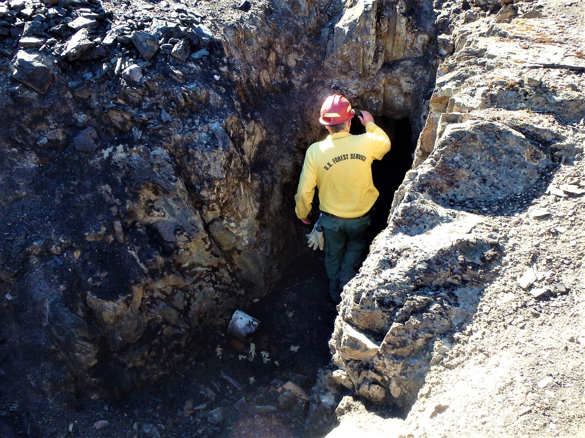 Image showing BAER environmental geologist Rick Weave assessing an abandoned mine opening opening near the Gorman Ranch Road, previously unknown that is now a threat to public safety in the Mosquito burned area