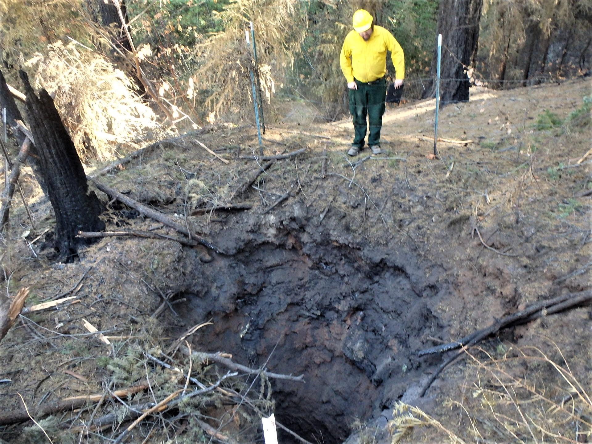 Image showing BAER abandoned mine specialist Jeremy Olsen assessing a burned over mine shaft in the Mosquito burned area