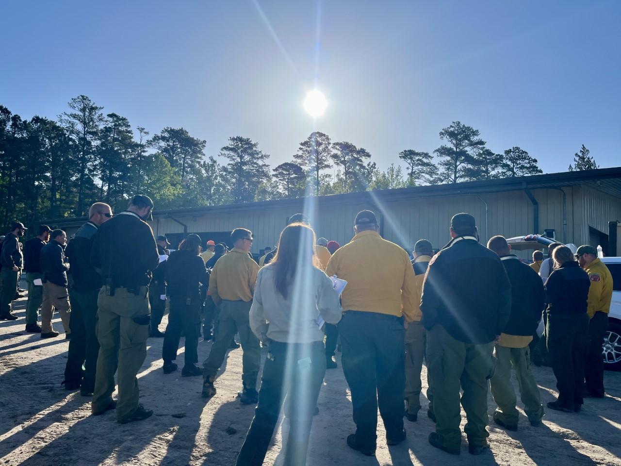 Firefighters and command staff on the Great Lakes Fire gather for morning briefing on April 25, 2023