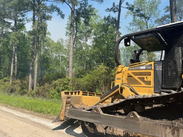 A large Dozer responds to the Great Lakes Fire on the Croatan National Forest in South Carolina.