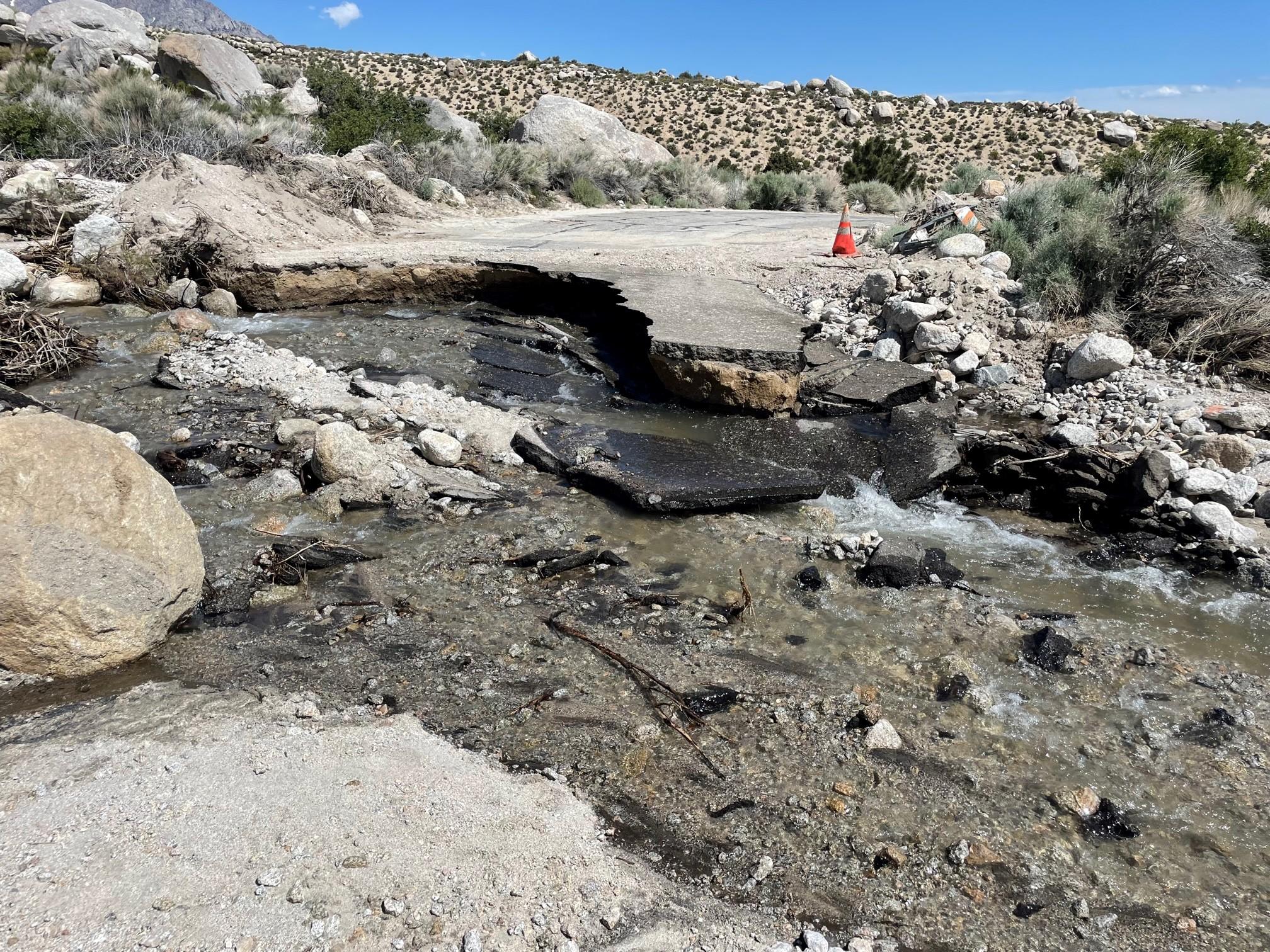 Image showing the road to Lone Pine Campground that has been washed out with water still running across the washed-out bed--photo take May 30