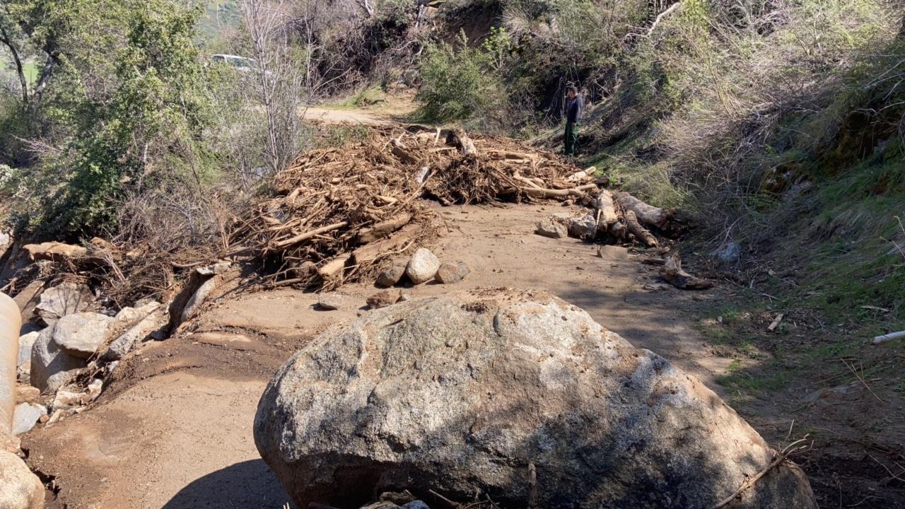 Debris and a large boulder on Forest Road 12S01 of the Sequoia National Forest.