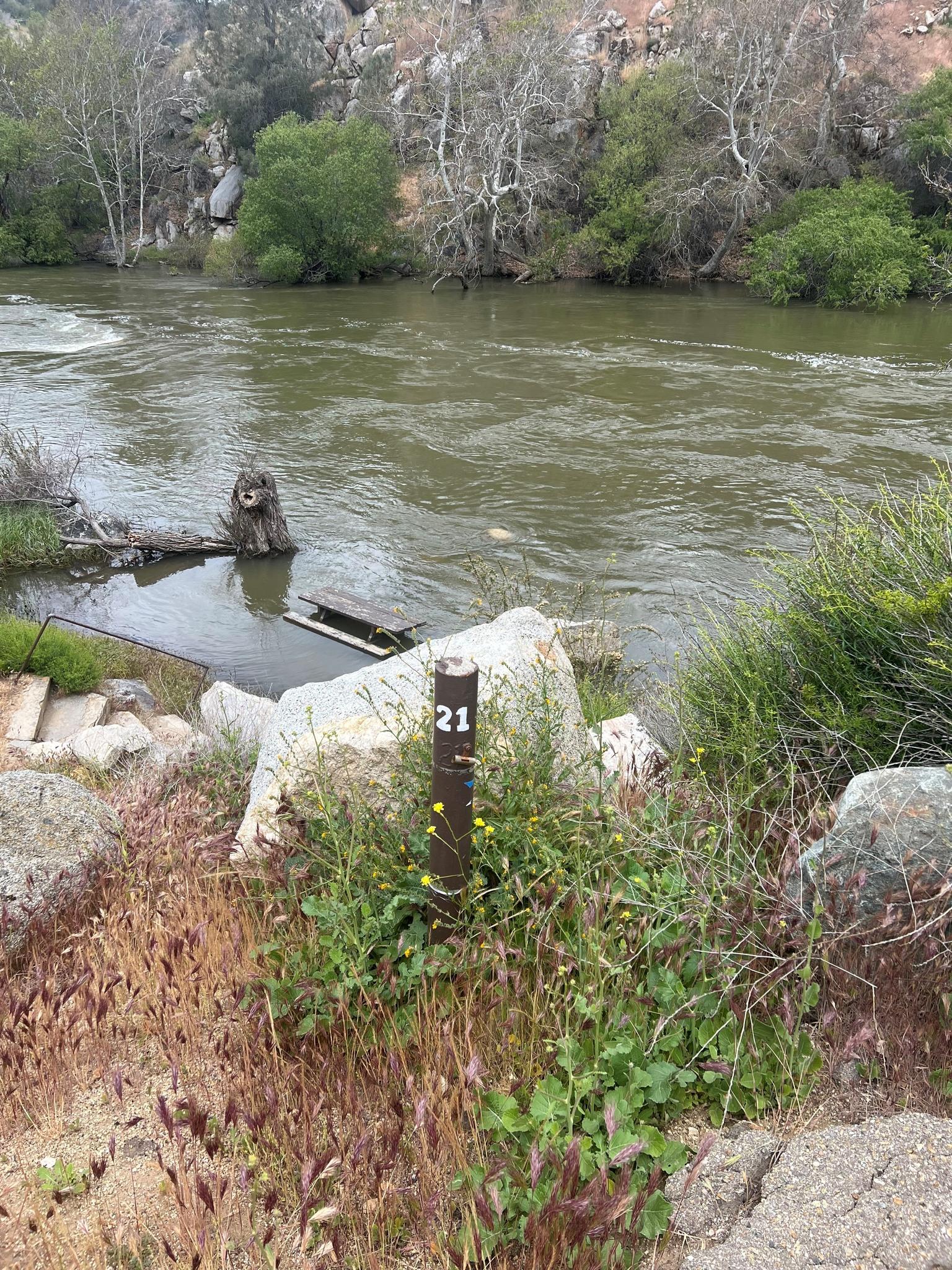 A picnic table in Hobo Campground is nearly submerged under the flooding water of the Kern River.