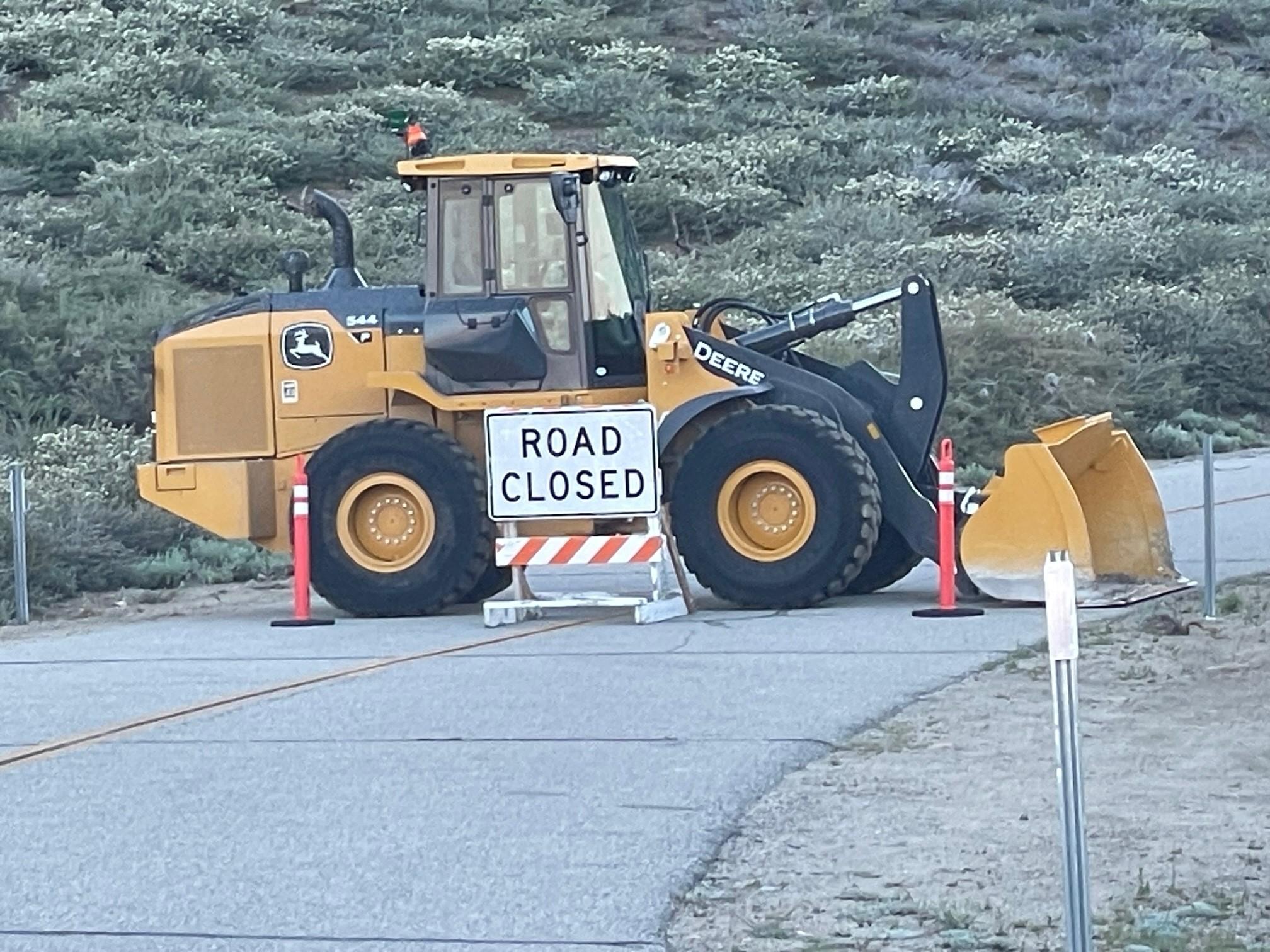 Image showing road closed sign alongside large dozer