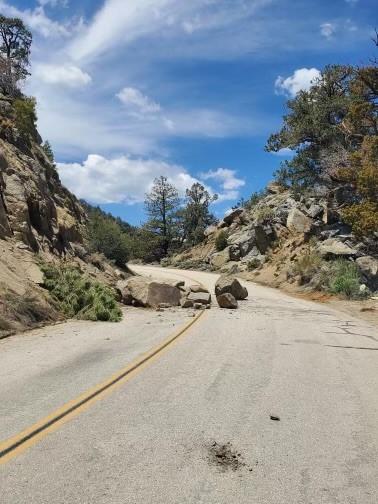 Rocks have tumbled off the hillside onto the highway near Sherman Pass on the Sequoia National Forest.