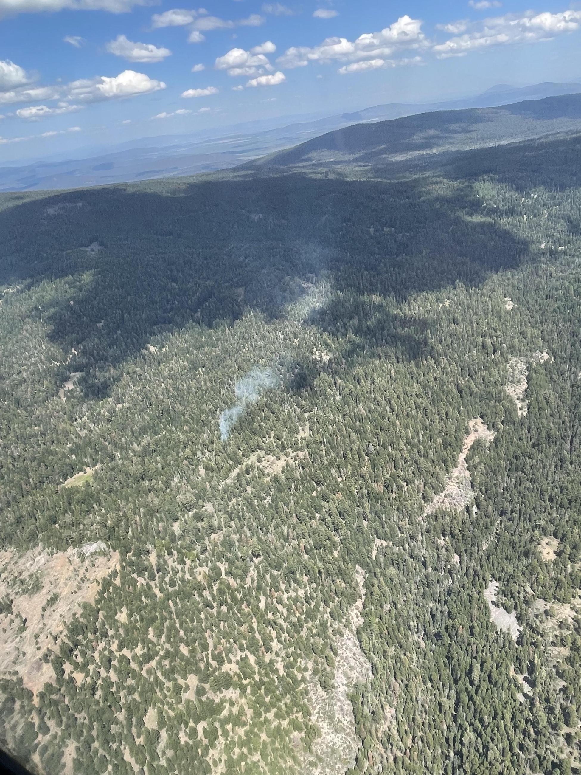 Small column of smoke rises from the Cold Fire on the Goosenest Ranger District of the Klamath National Forest.
