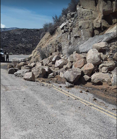 Large rocks block the inside travel lane of the Sherman Pass Road on the Sequoia National Forest