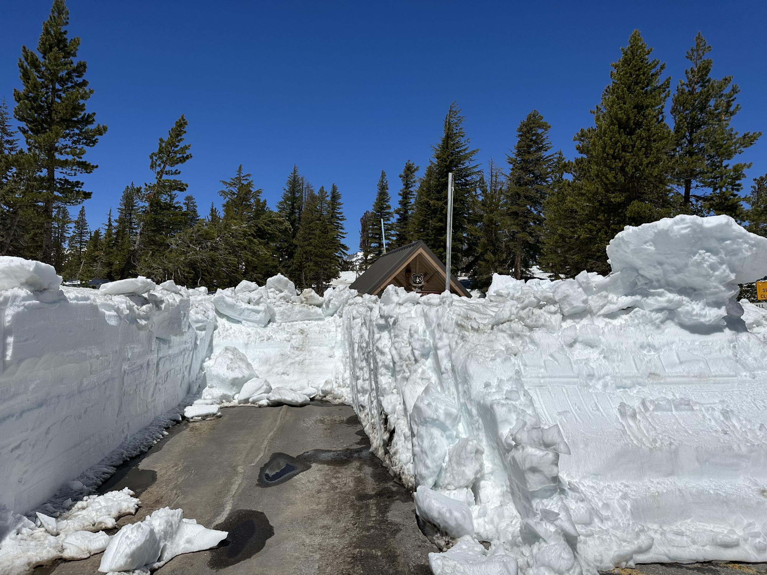 June 20, 2023, Image of many feet of white snow across closed Red's Meadow Road at Minaret Summit
