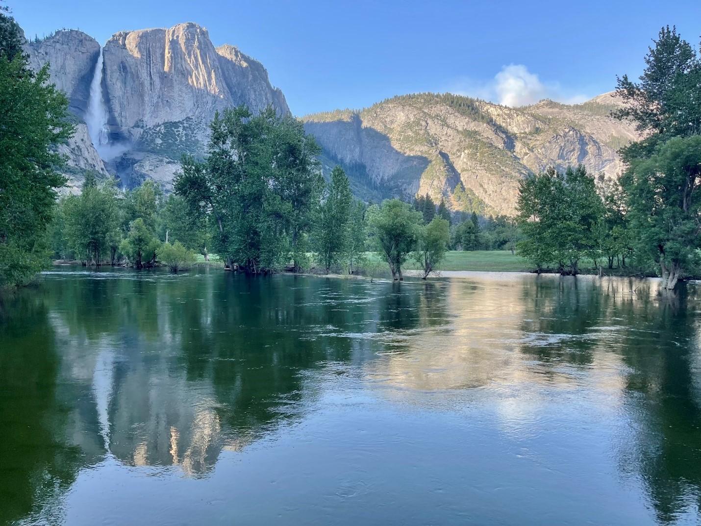 Yosemite Valley, with smoke seen on the horizon reflected in the Merced River.