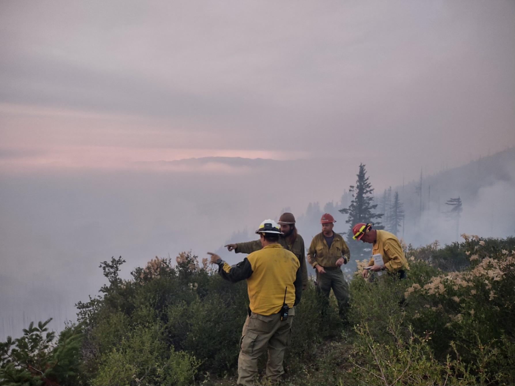 Firefighters evaluate, document and discuss fire weather conditions on the Flat Fire during day shift on July 22, 2023