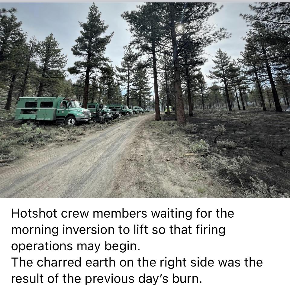 Image showing Hotshot crew members waiting for morning inversion to lift so that firing operations may begin. The charred earth on the right side was the result of the previous day's burn