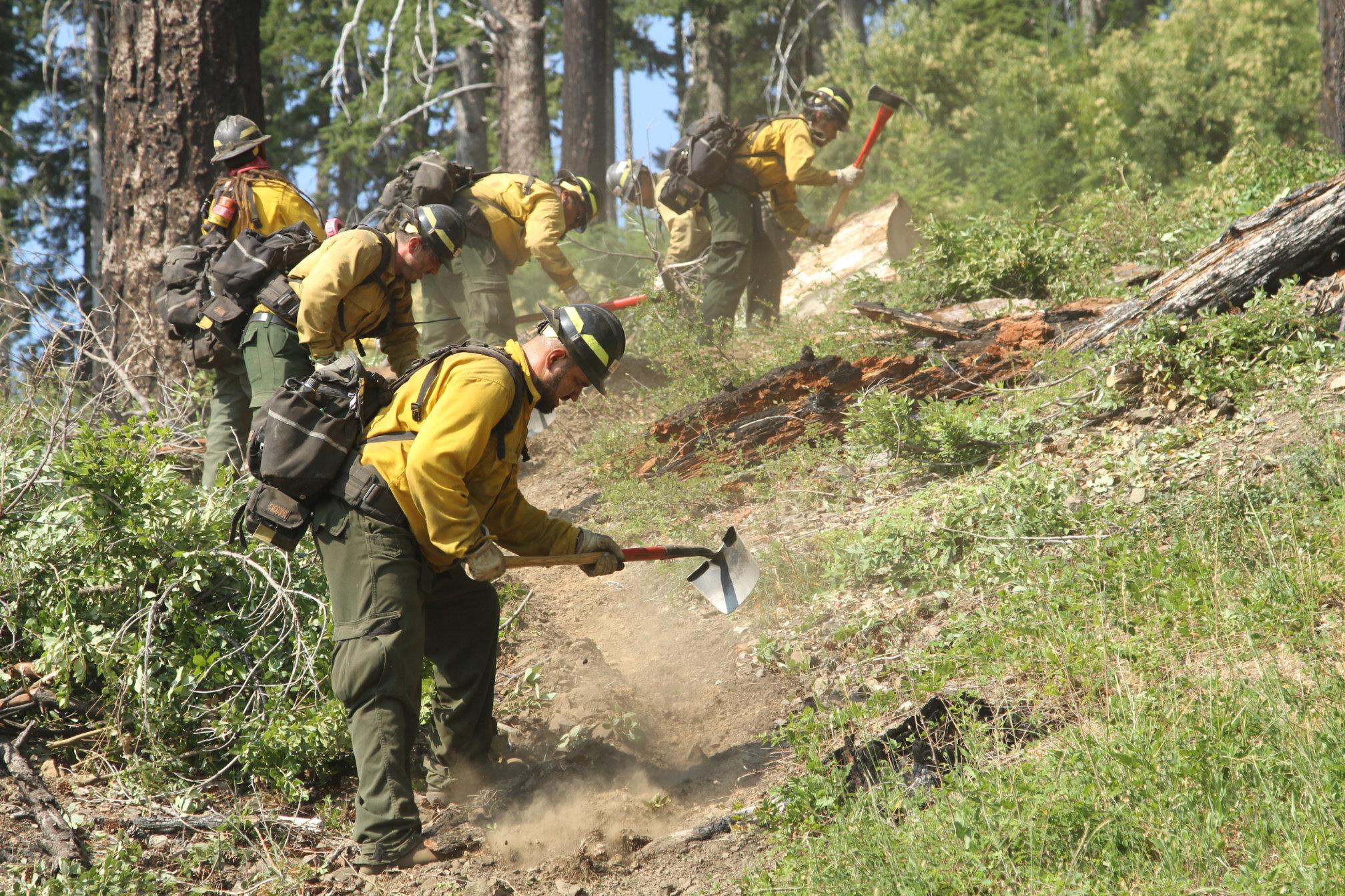 Firefighters from ASI Type 2 Handcrew dig a handline in the northeast portion of the fire.