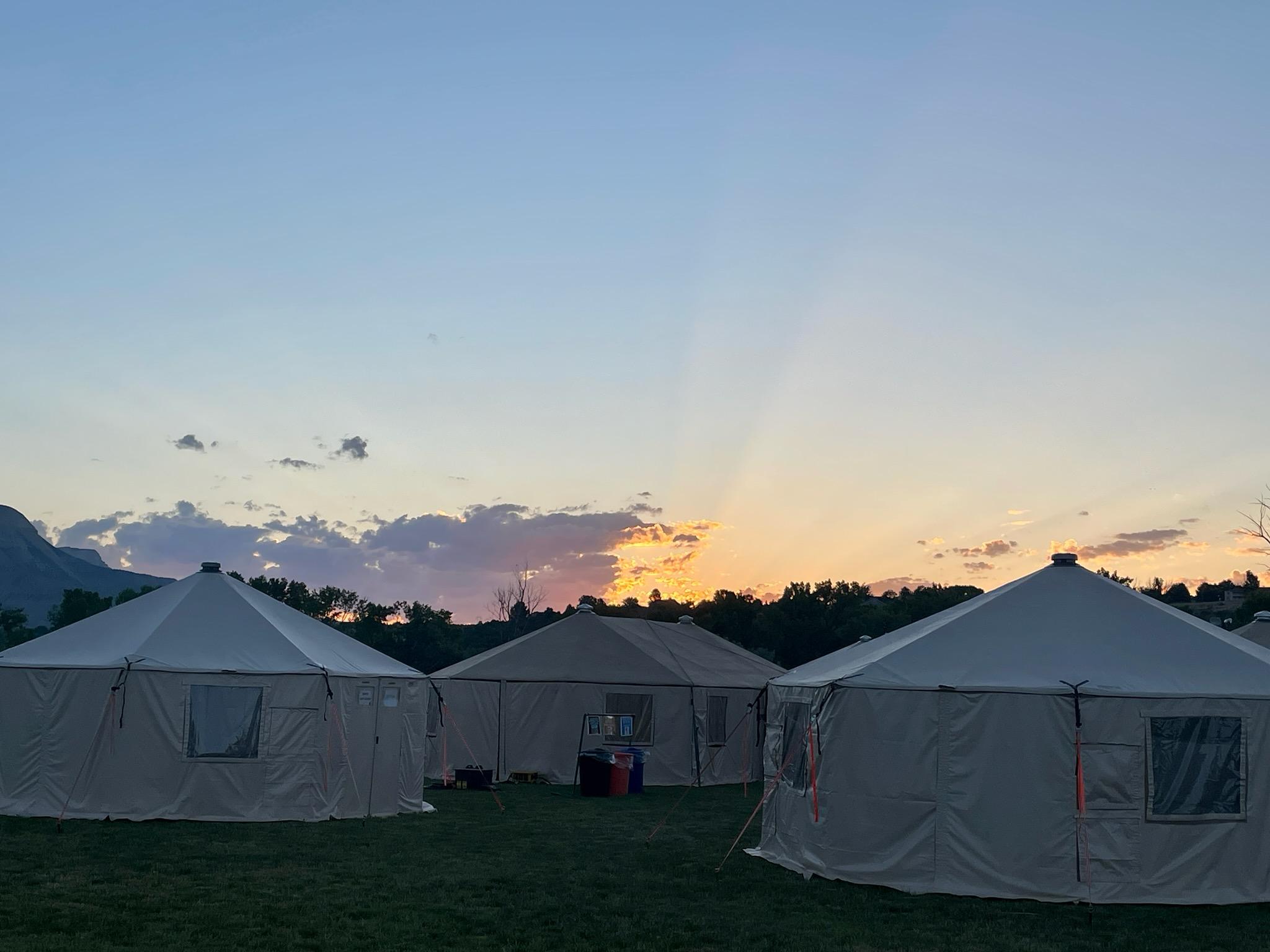 sunrise behind command post yurts