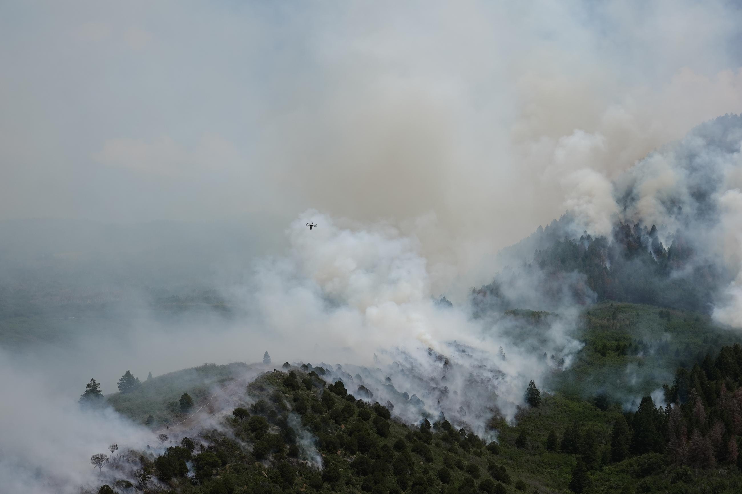 a drone hovers over smoke during a firing operation 