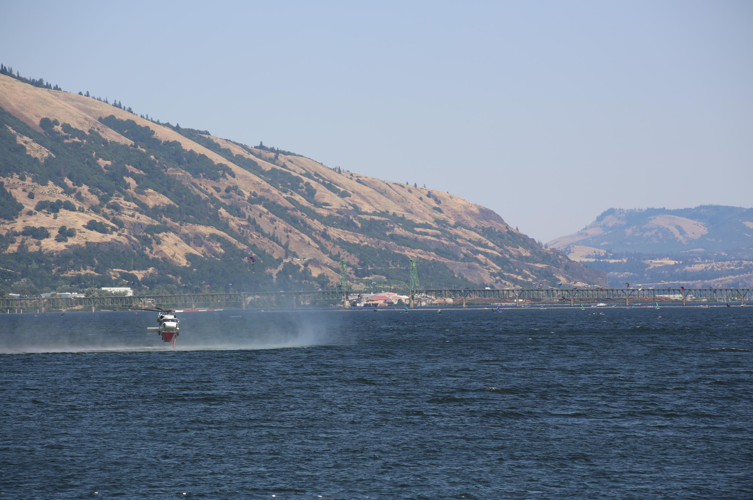 Helicopter dipping for water in the Columbia River.