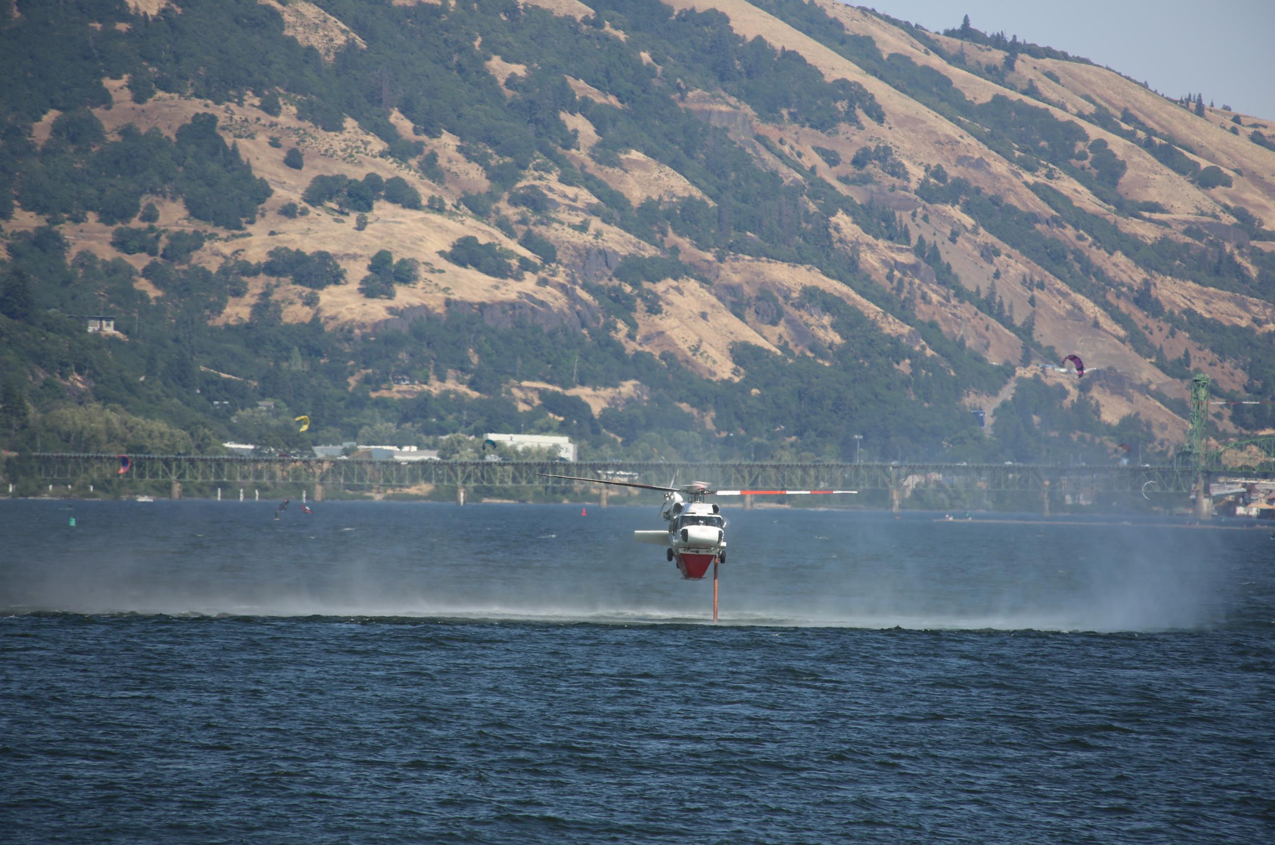 Helicopter dipping for water in the Columbia River.
