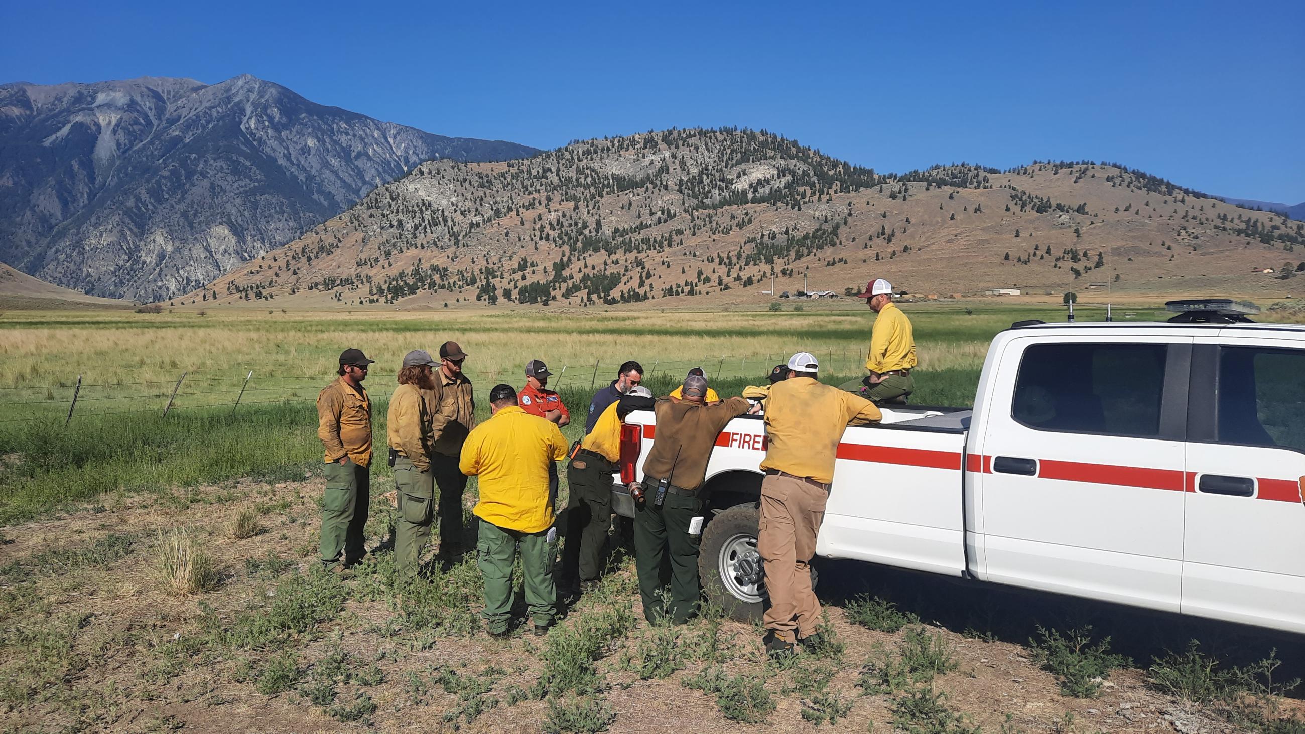 Command staff from both the American and Canadian incident management teams meet along the American-Canadian border to discuss and shared containment strategy.