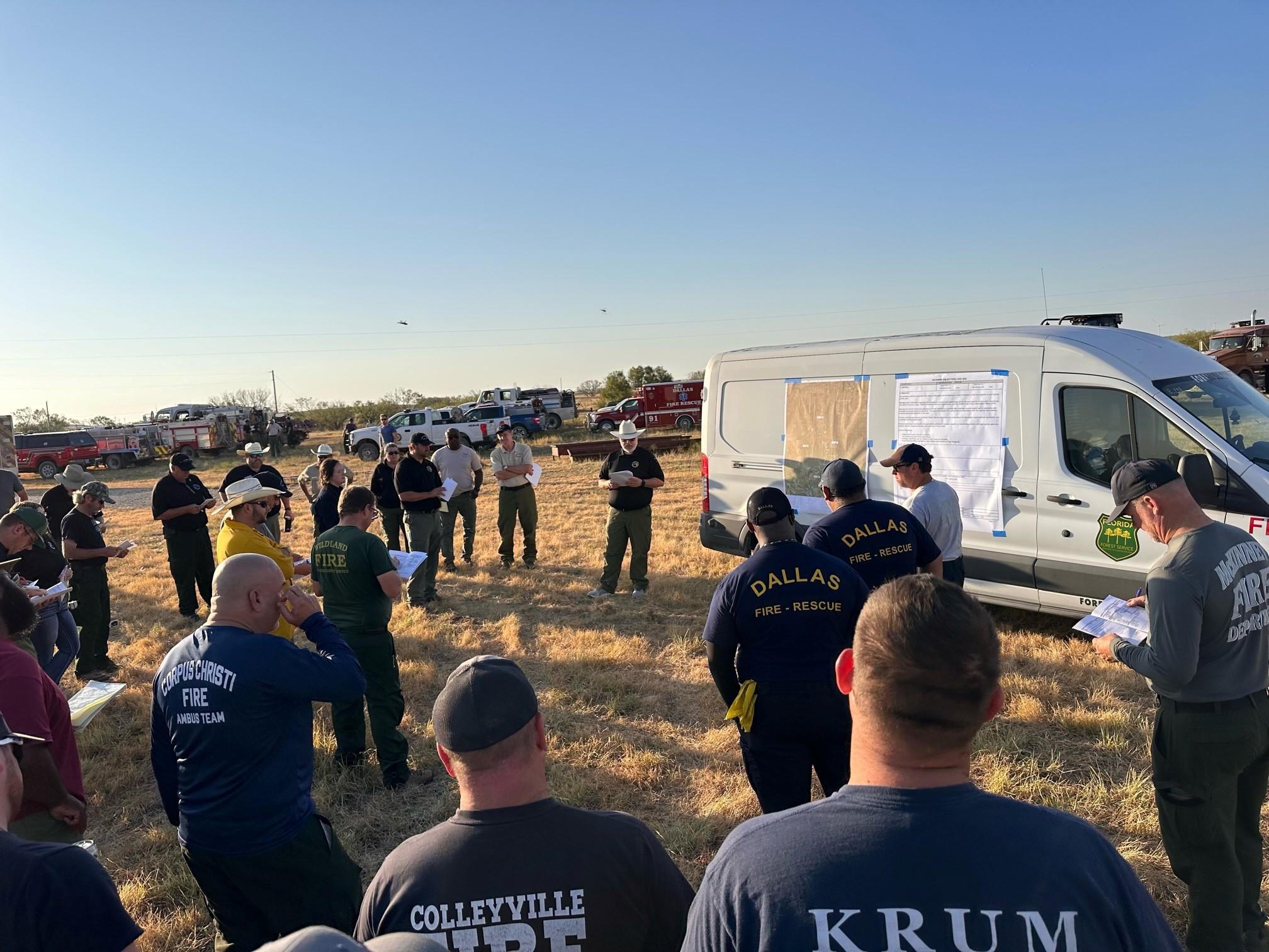Morning operations briefing in the field before crews get to work.