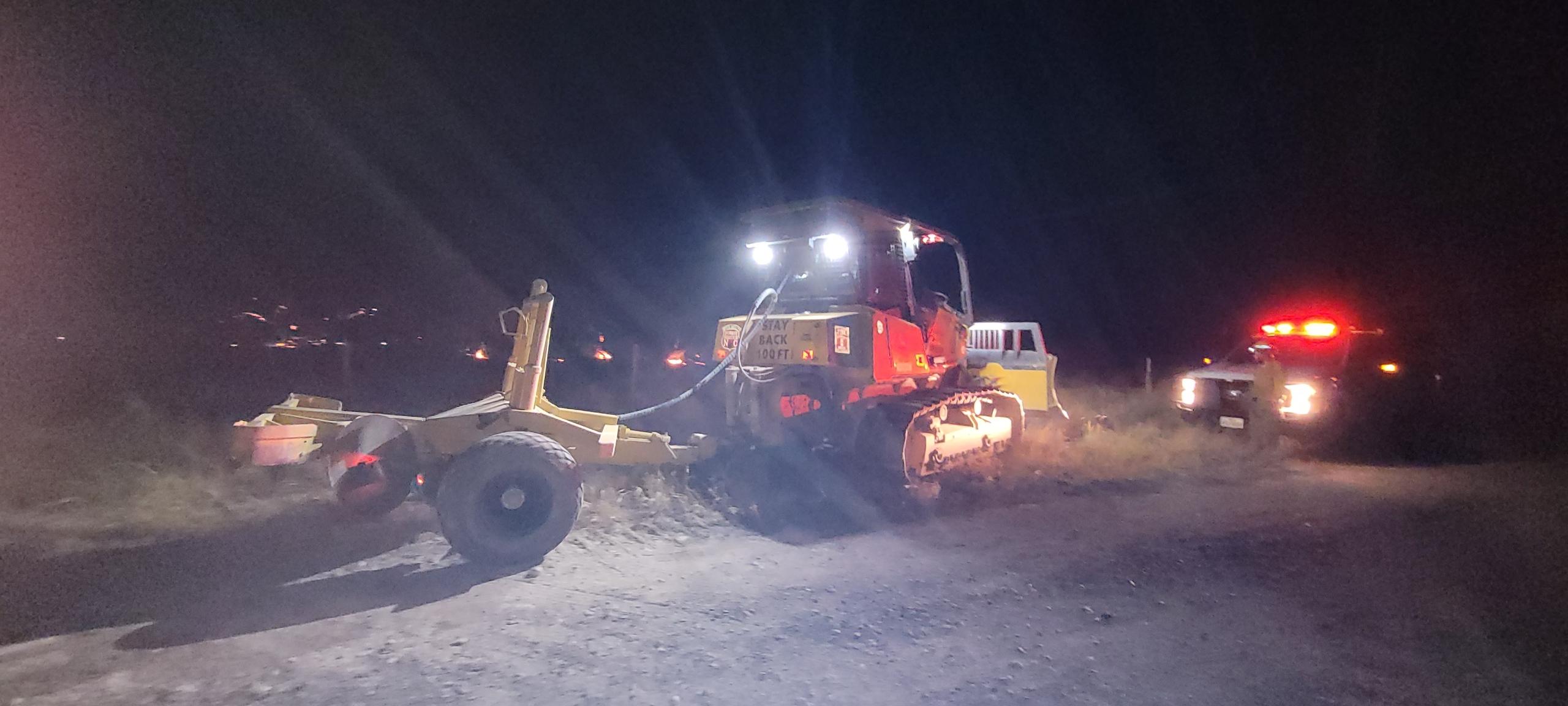 Dozer using plow to construct fireline