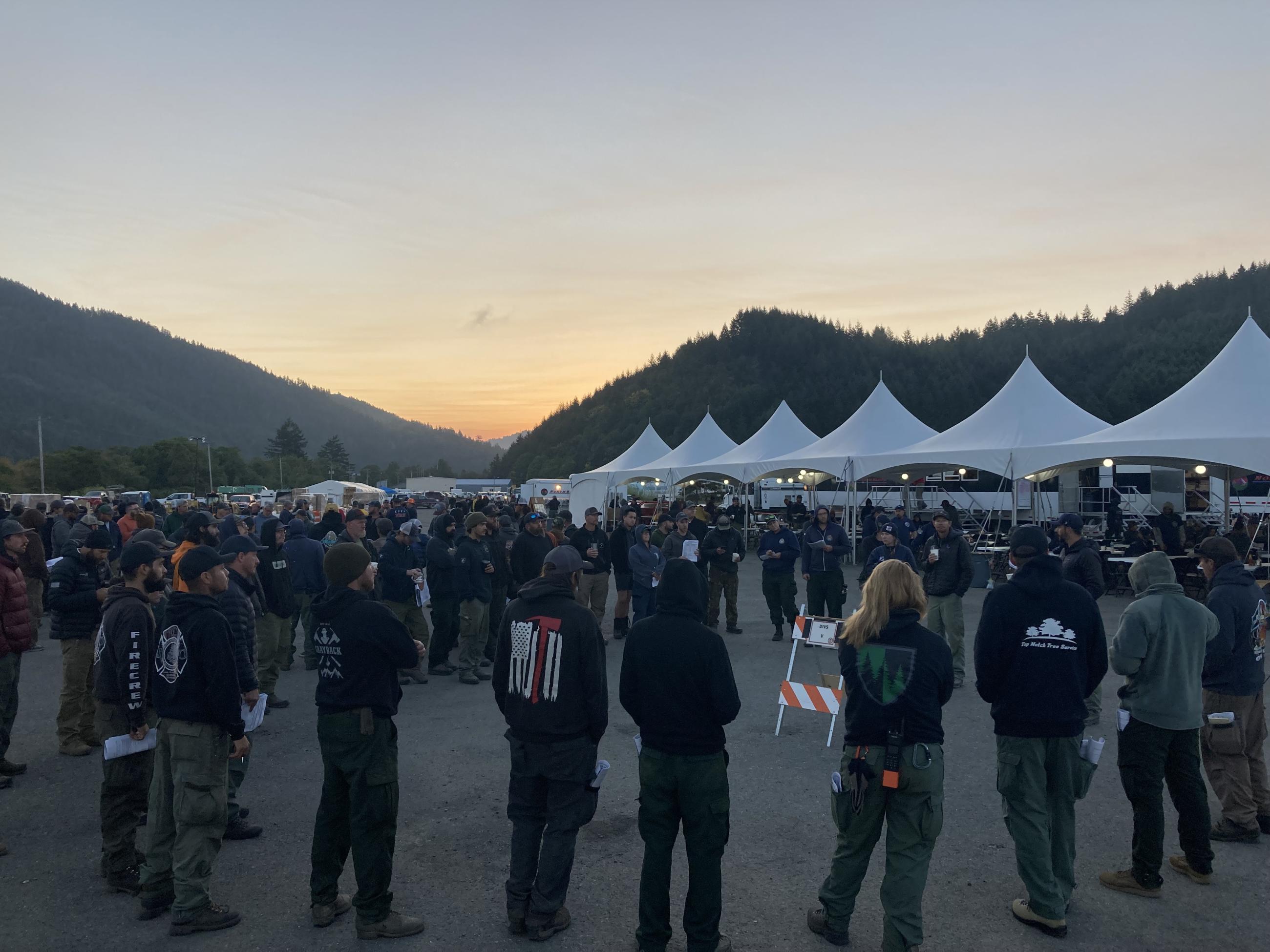 Firefighter circled up for discussion at fire camp