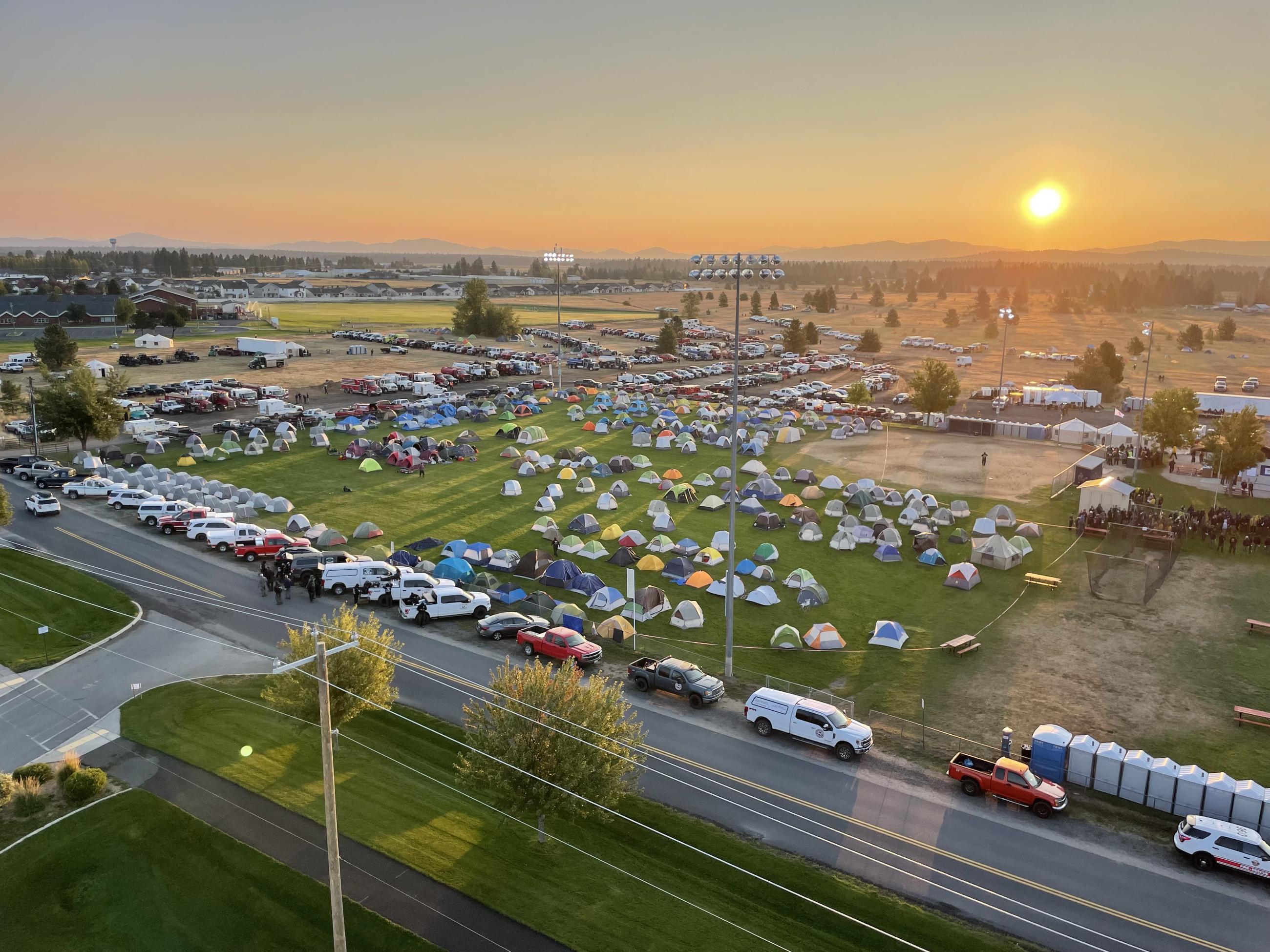 Overview photos of tents and parked vehicles 