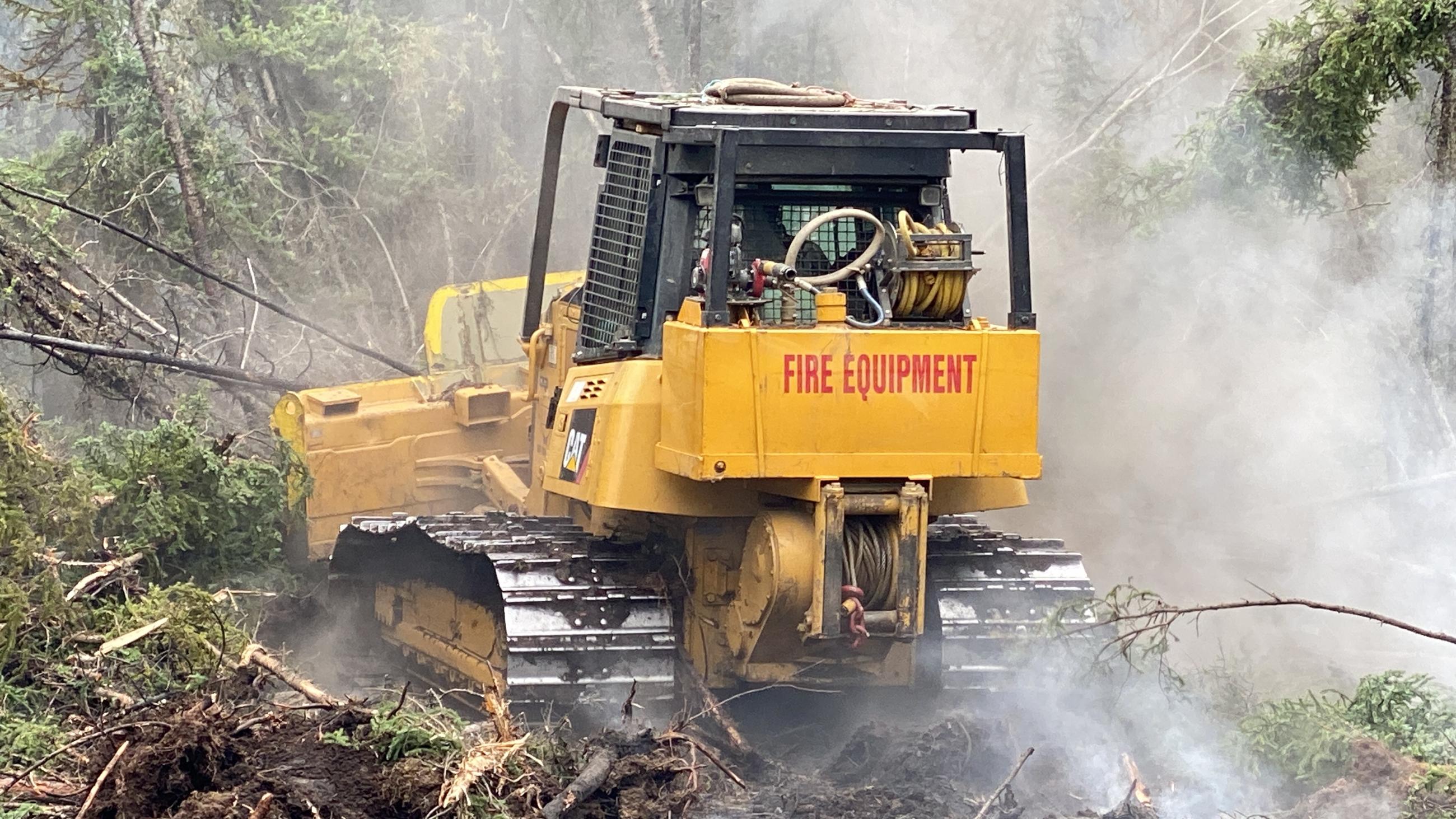 Dozer line construction in thick black spruce to protect private homes and infrastructure within the Pogo Mine Road.