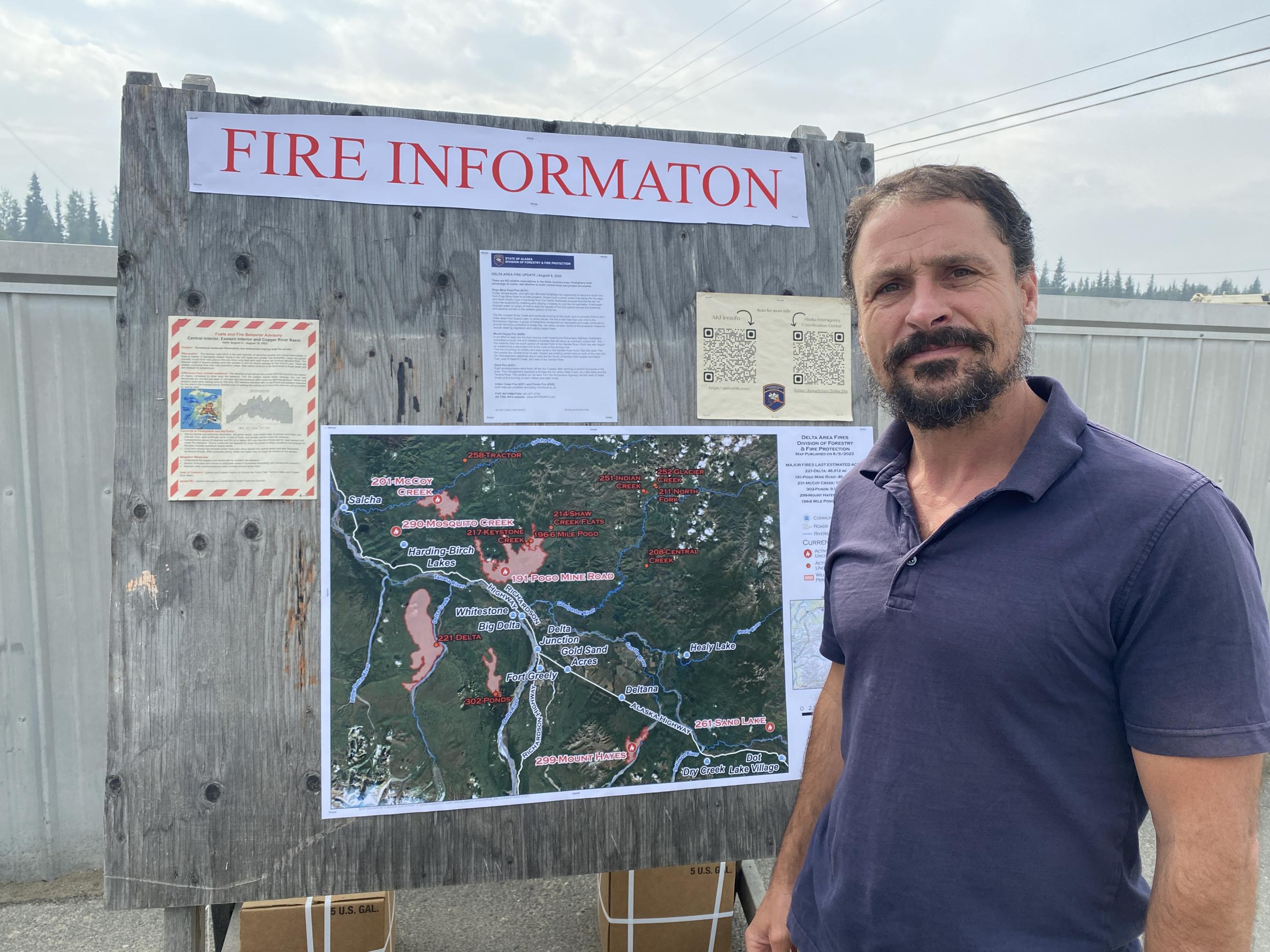 Public information officer Jacob Welsh posting information on sign boards in the Delta Junction area for on Pogo Mine Road Fire #191 and Mount Hayes Fire #299. 