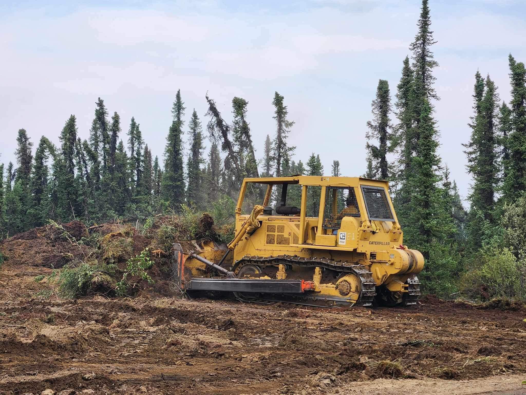 A bulldozer clearing trees.