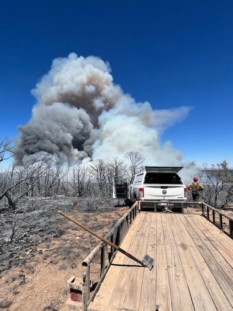 Smoke rises from the Kane Fire as crews respond to suppress the wildfire.