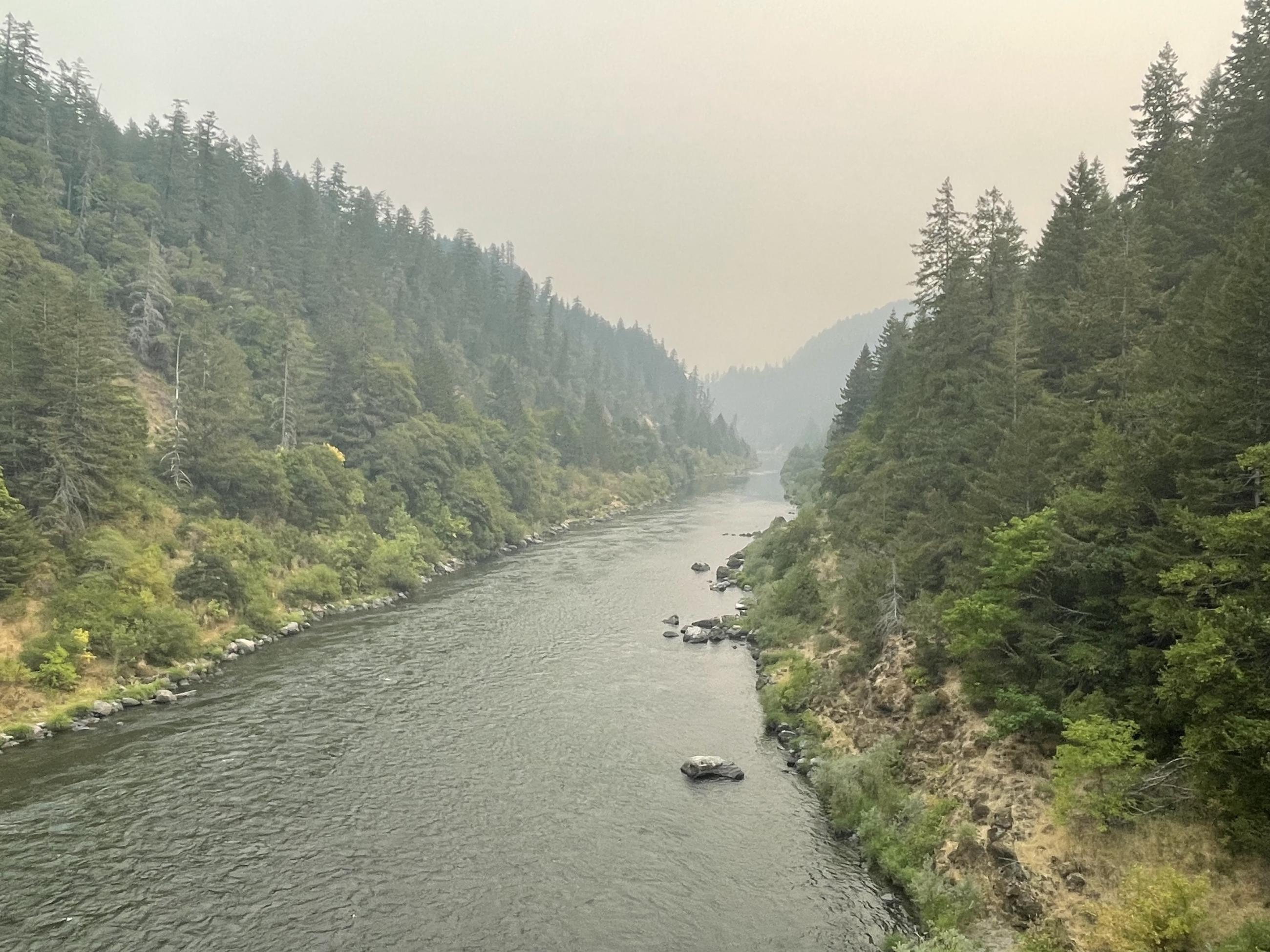 Smoke obscures the ridge line looming over the Rogue River