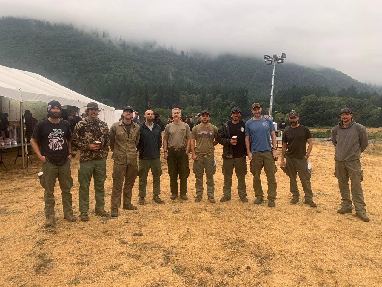 10 firefighters standing in a row at the morning briefing on the 2023 SRF Lightning Complex and Redwood Lightning Complex