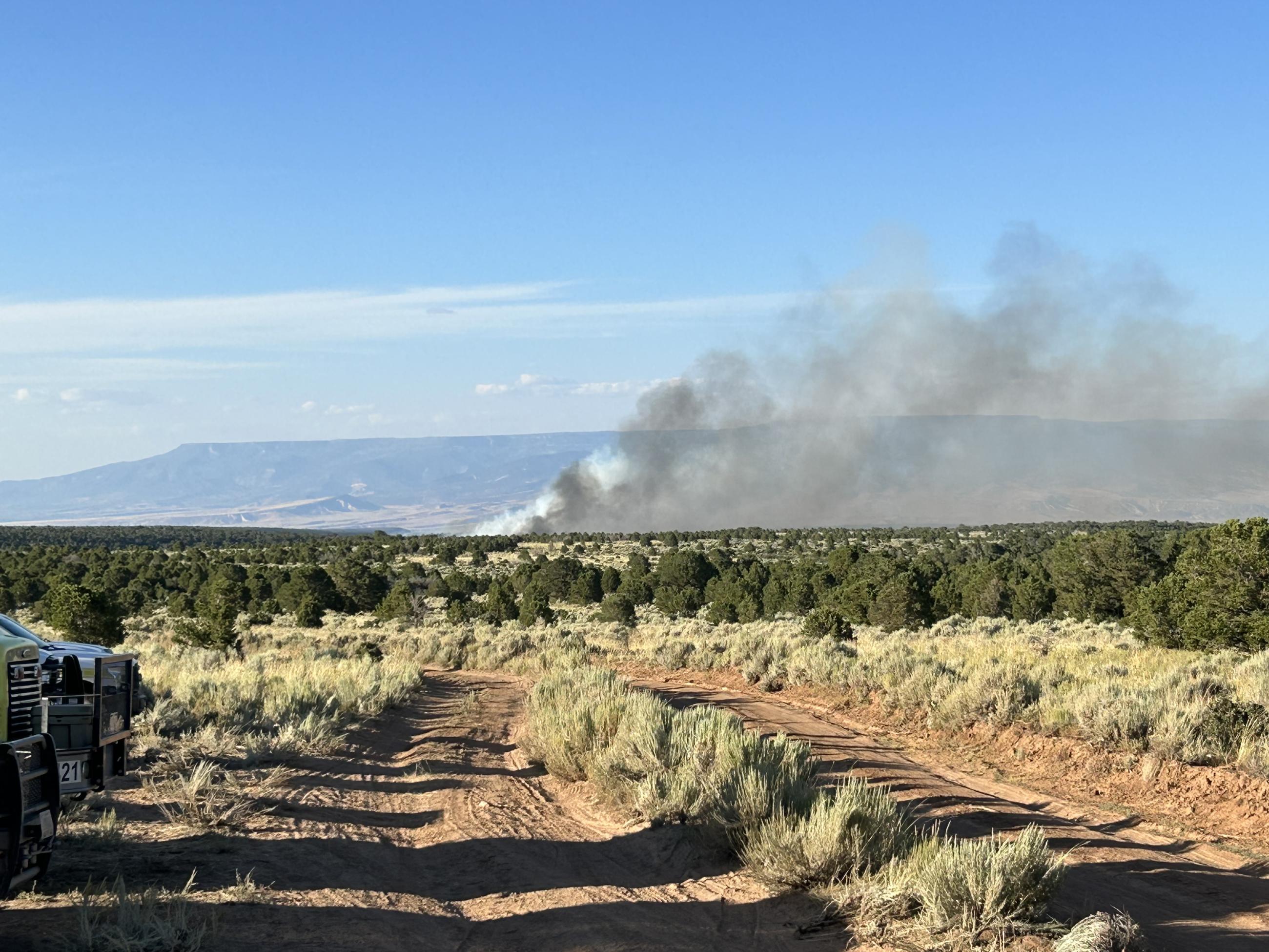 This is a photo showing smoke from the Little Mesa Fire with a silhouette of Grand Mesa in the background.