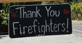 A sign posted by a local business that reads "Thank You Firefighters" to showcase support for firefighting personnel.