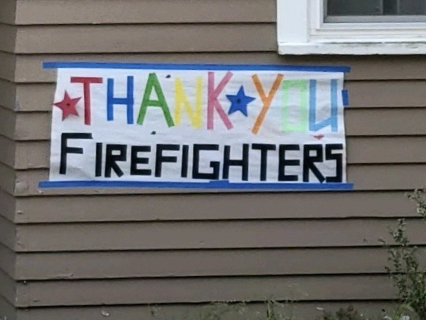 A sign posted by local community members that reads "Thank You Firefighters" to showcase support for firefighting personnel.