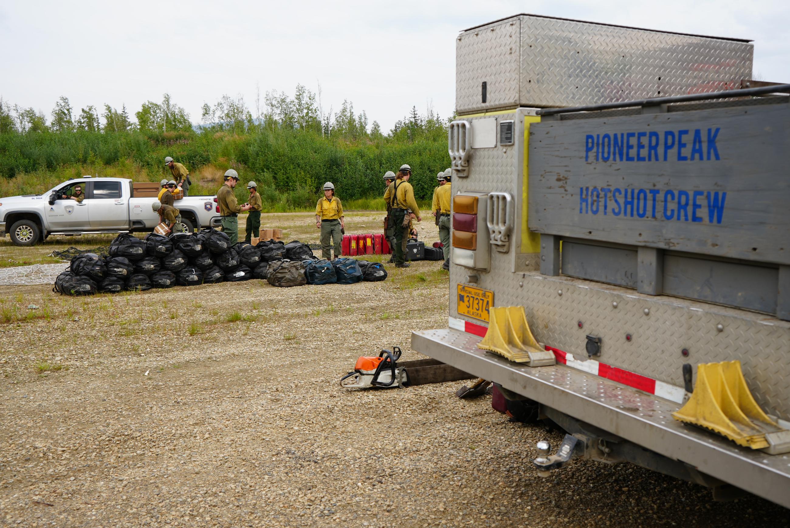 Fire fighters and trucks in the lot.