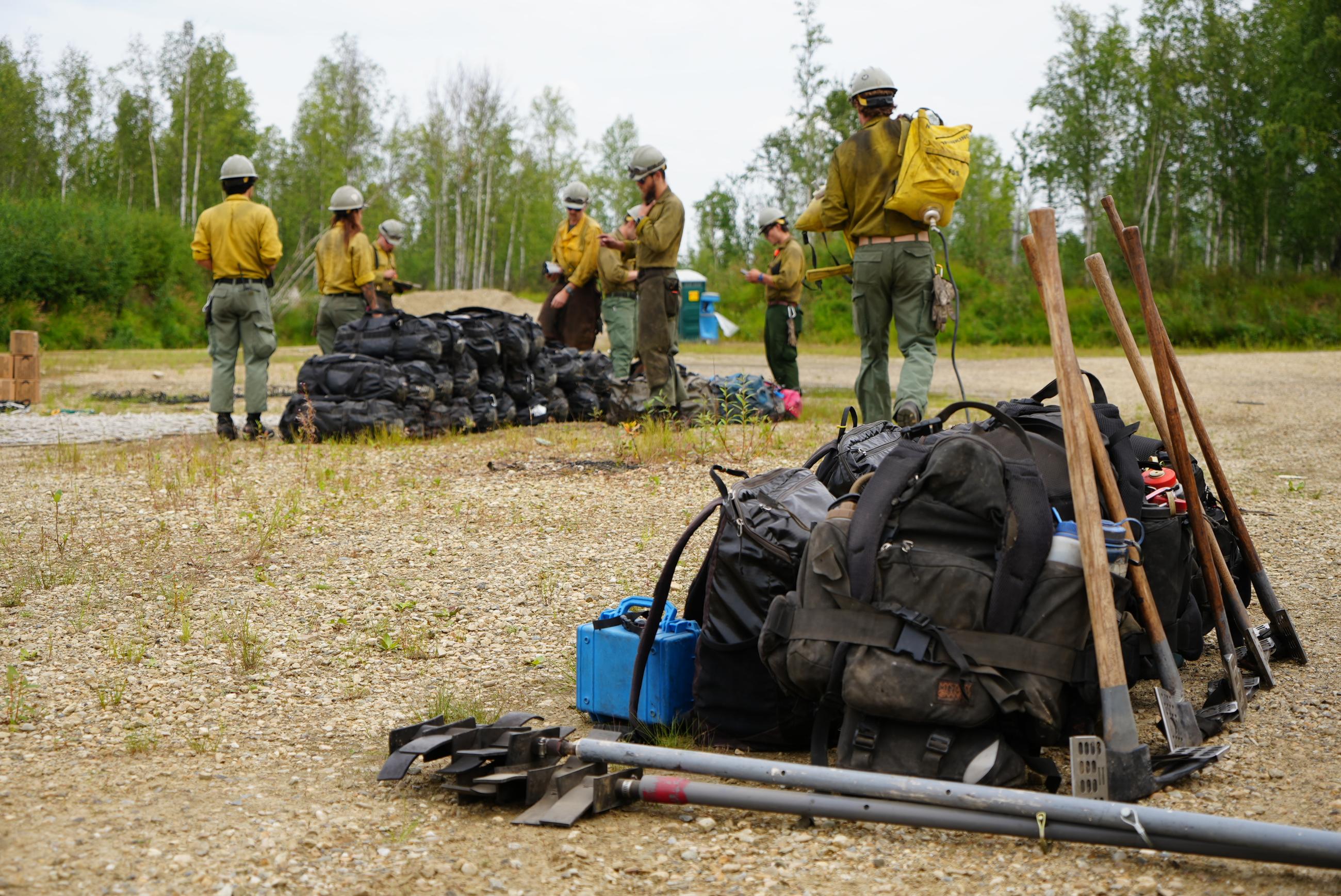 Piles of gear and a firefighting crew.