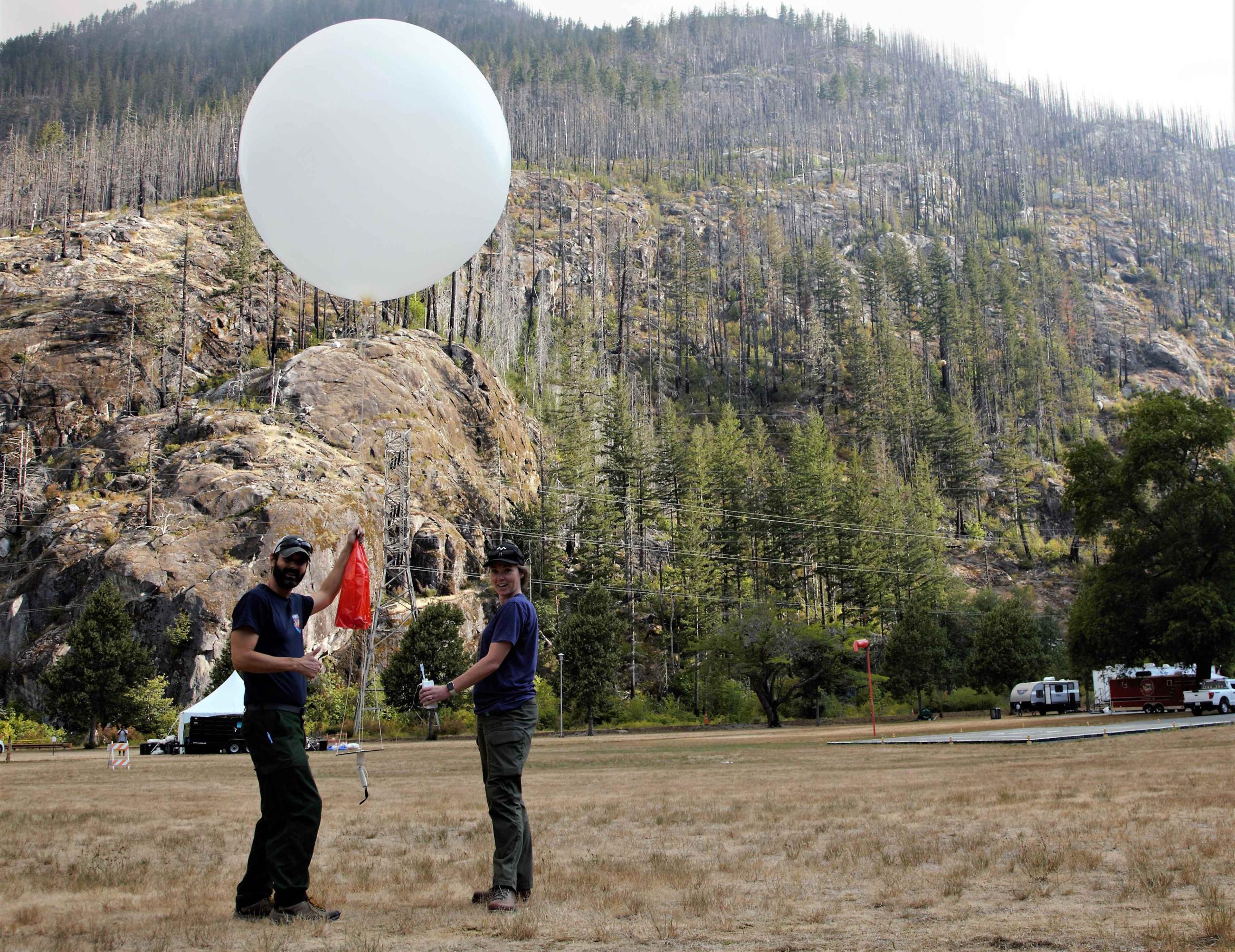A photo of personnel sending a weather balloon into the air taken on August 16, 2023