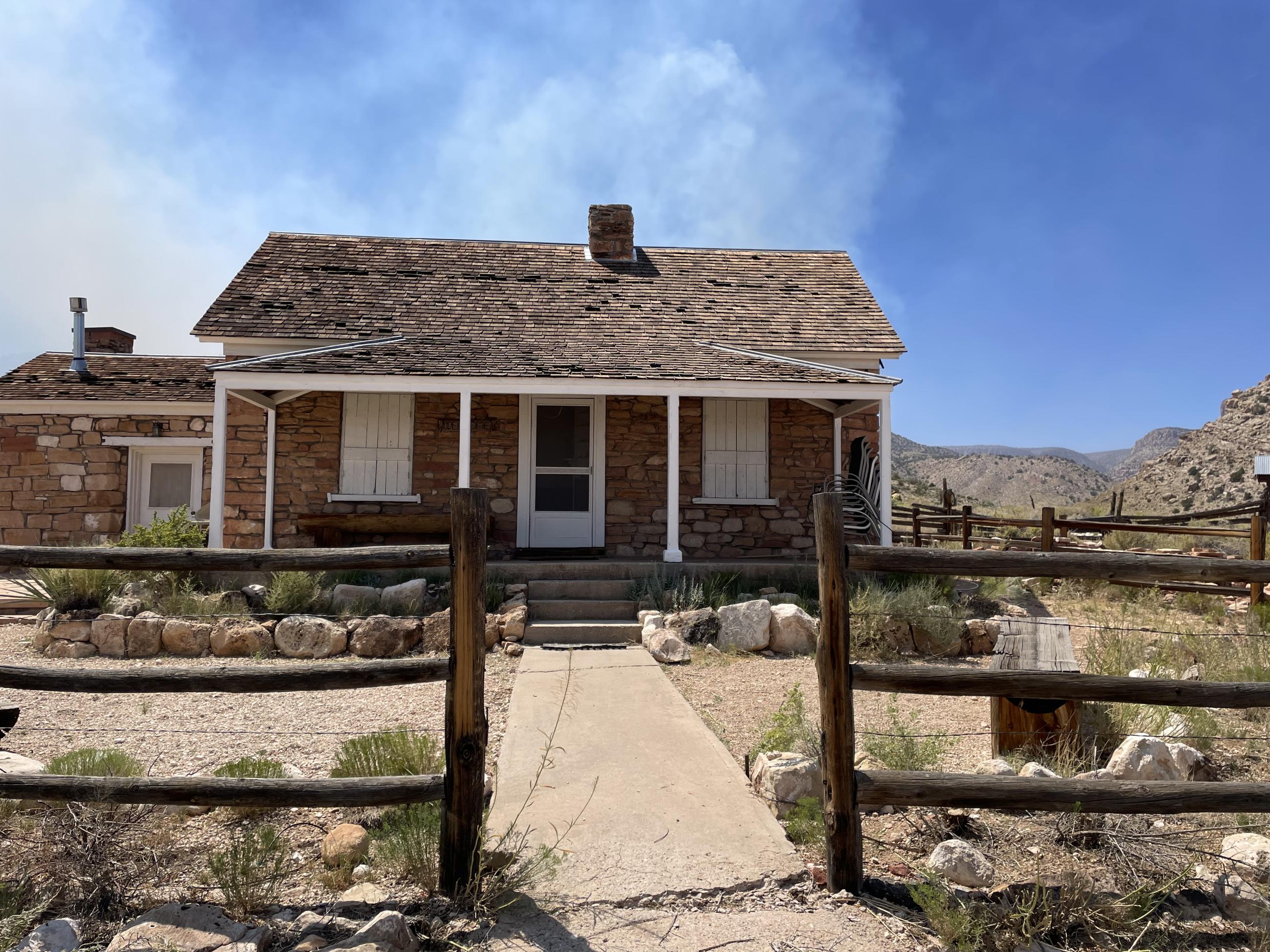 historic kane ranch house with smoke in background