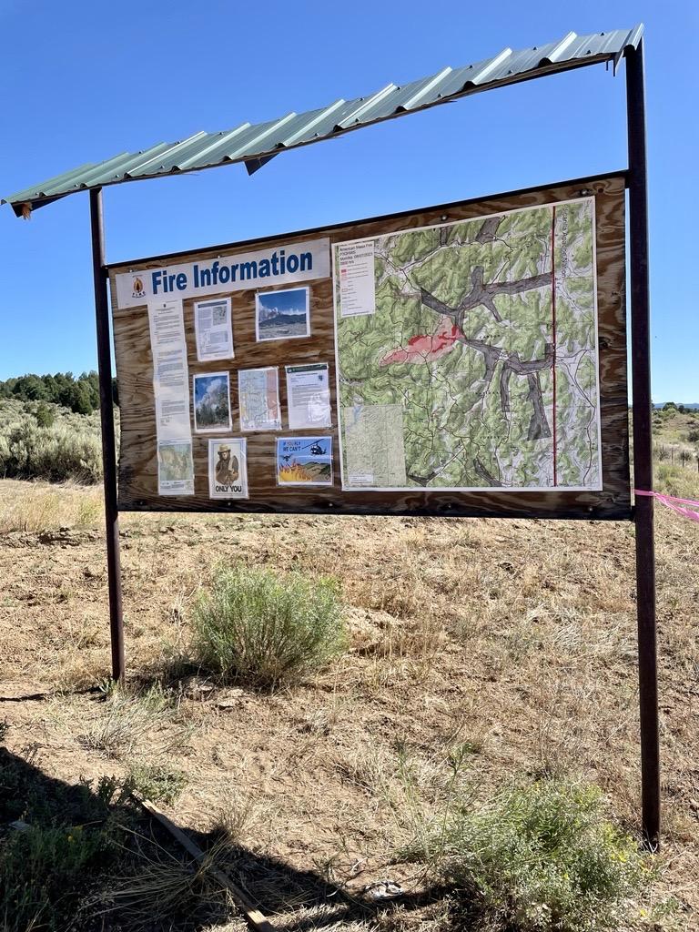 FireInformation: Photo of the fire information board for the American Mesa Fire. Board is displayed off Highway 64 and Forest Service road 310.  