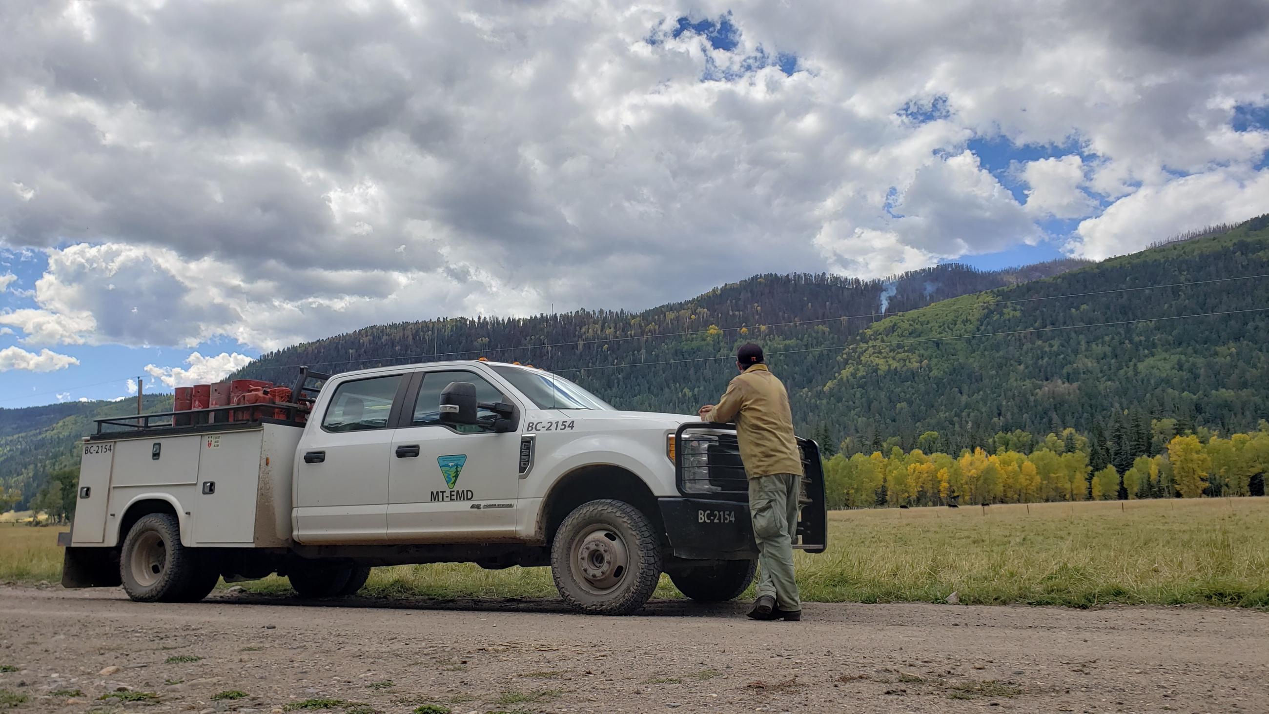 Picture shows division supervisor observing smoke in the Shaw Creek drainage.