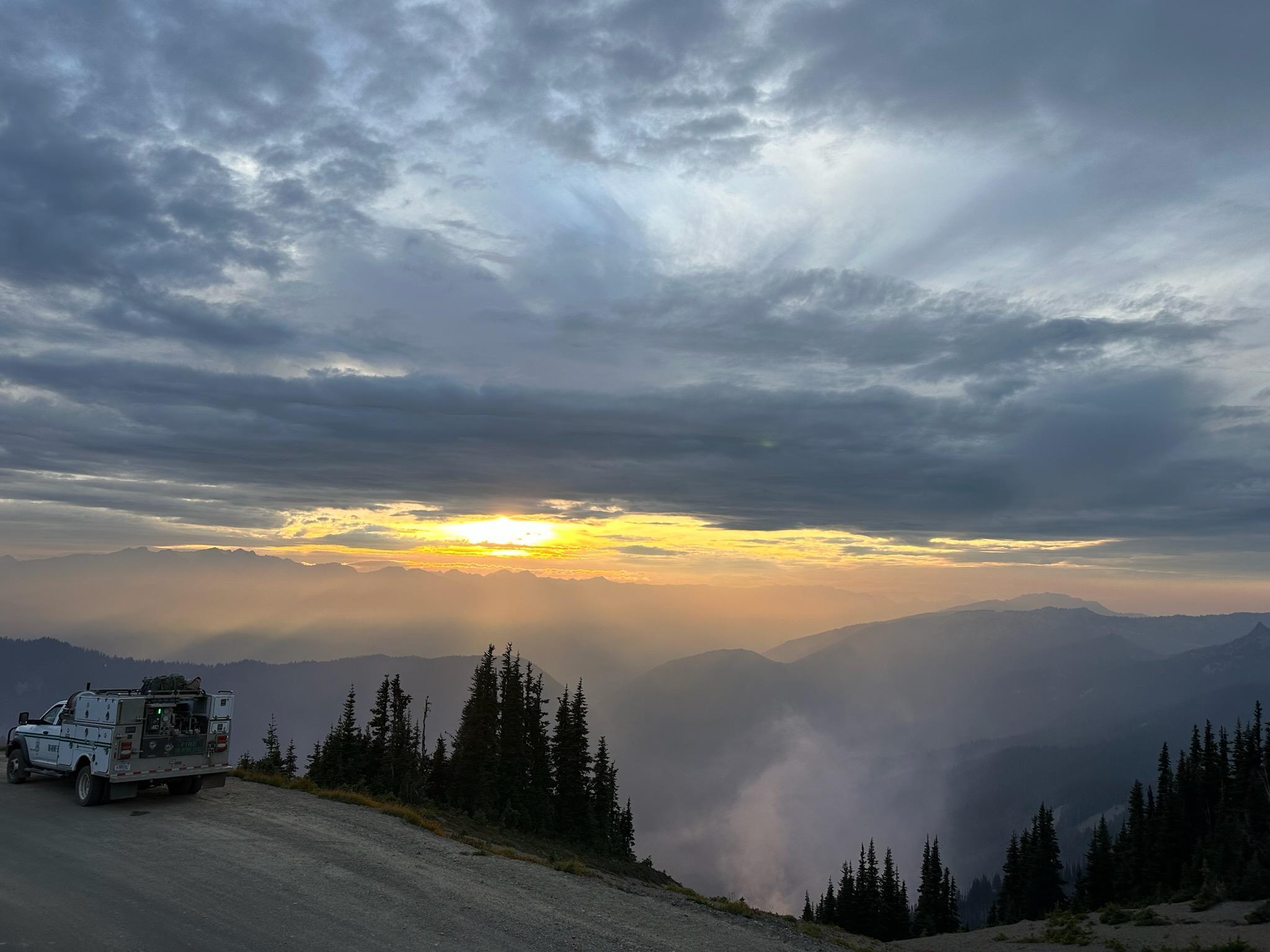 A fire engine crew observes fire activity from the Obstruction Point Road in Olympic National Park.