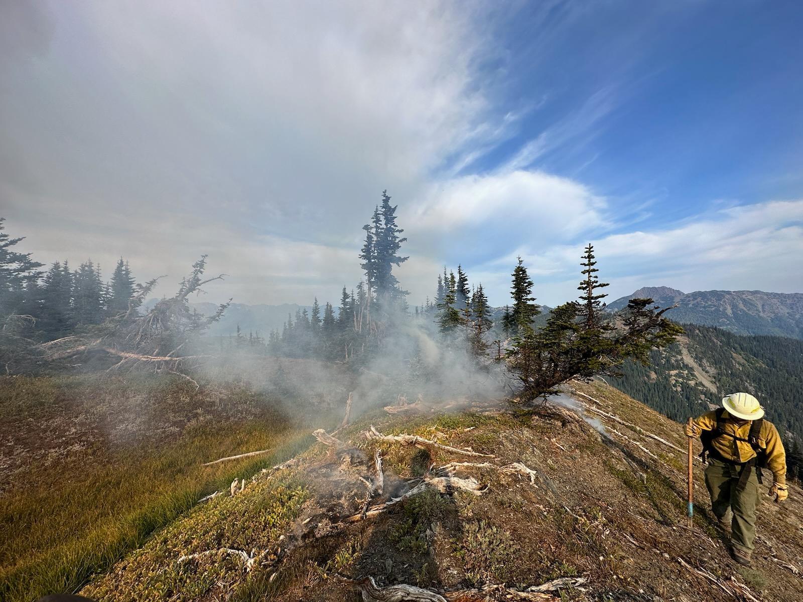 A firefighter works along the edge of the Eagle Point Fire in Olympic National Park.