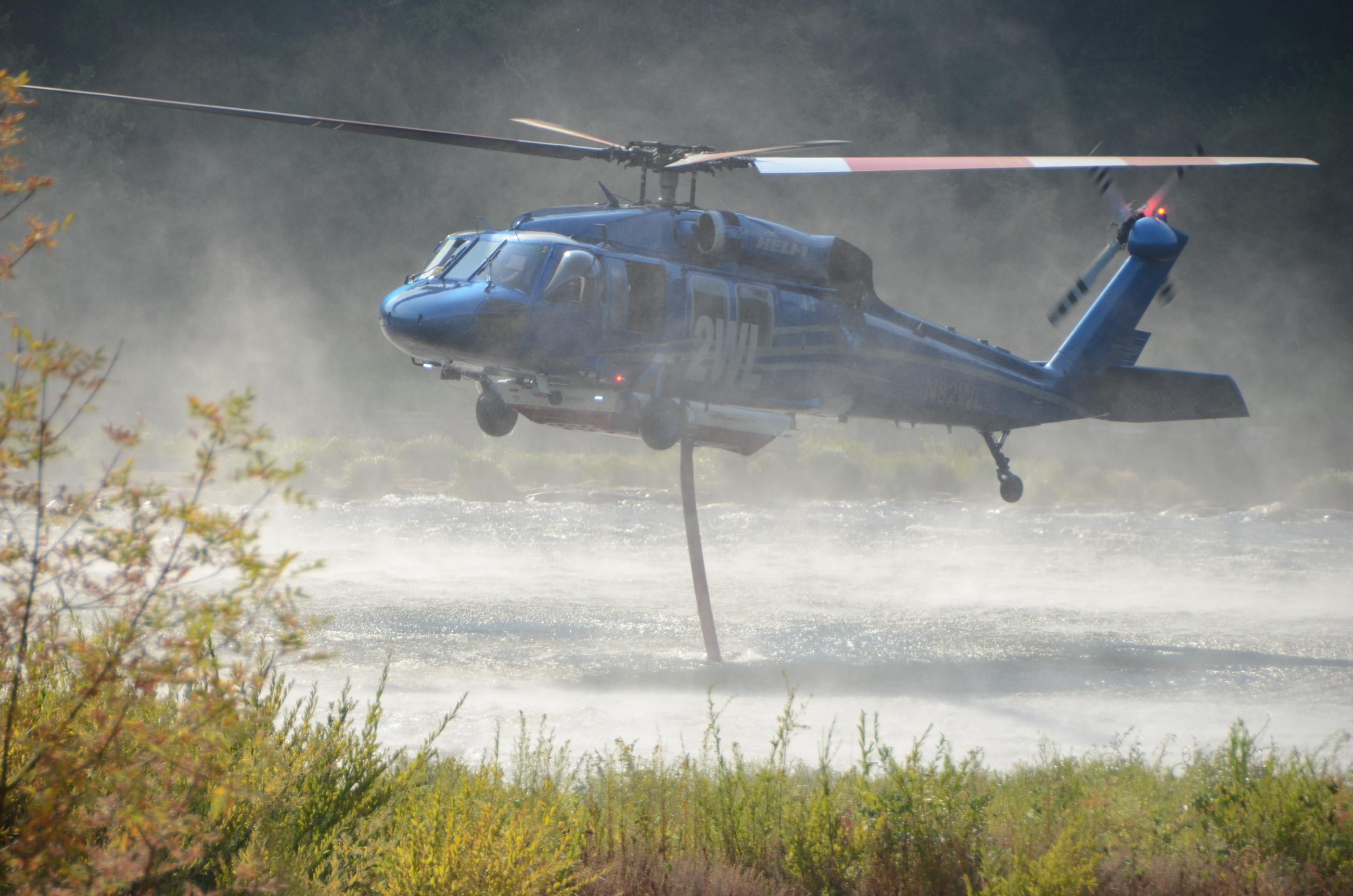Helicopter loading water from Umpqua River