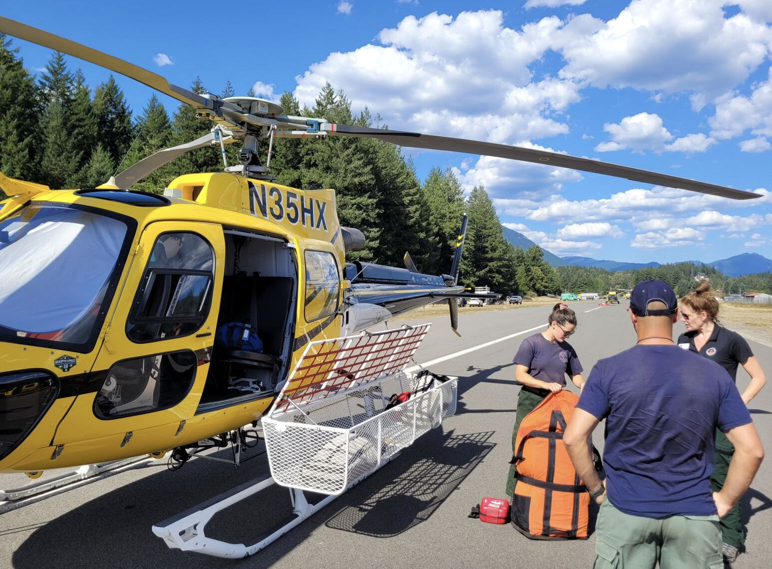 Gear is loaded into the side baskets on a helicopter