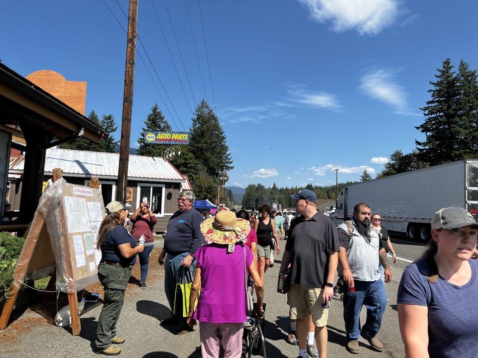 A PIO provides fire information to the public at one of the traplines at the Packwood Flea Market fire information boards