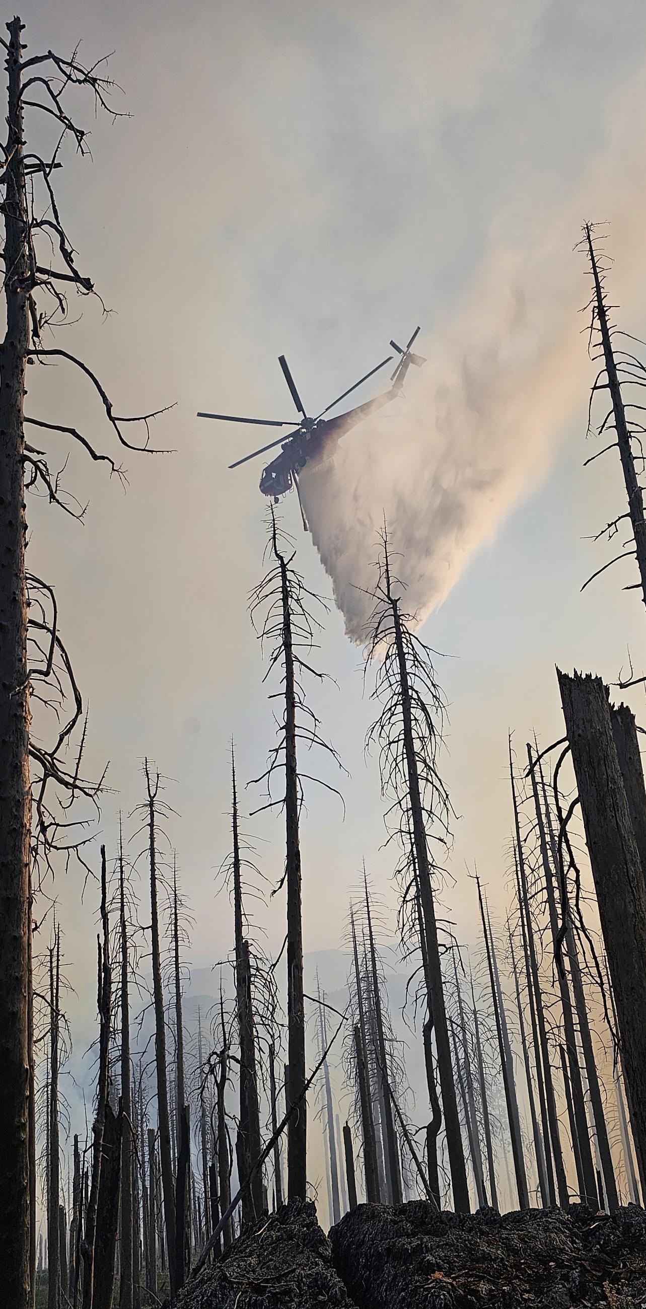 Helicopter making a water drop on Division A